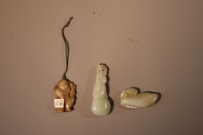 CHINA, About 1900
Three jade (nephrite) pendants...