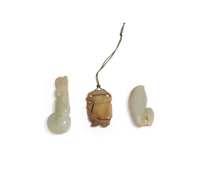 CHINA, About 1900
Three jade (nephrite) pendants...
