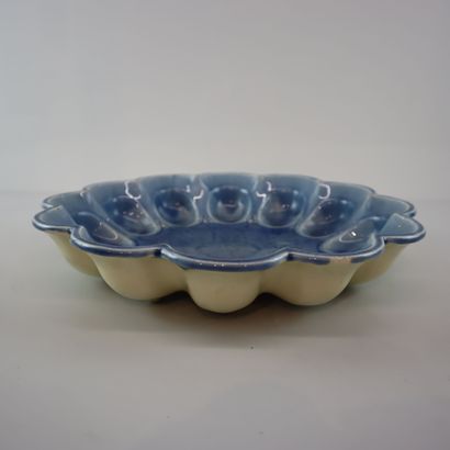 Blue ceramic egg dish with stylized floral...