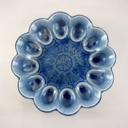 Blue ceramic egg dish with stylized floral...