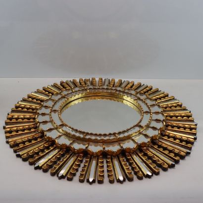 Round gilded metal mirror in the shape of...