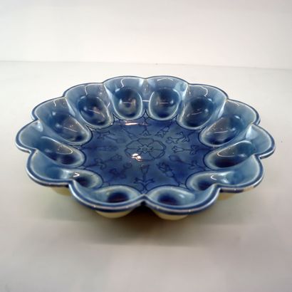 Blue ceramic egg dish with stylized floral...
