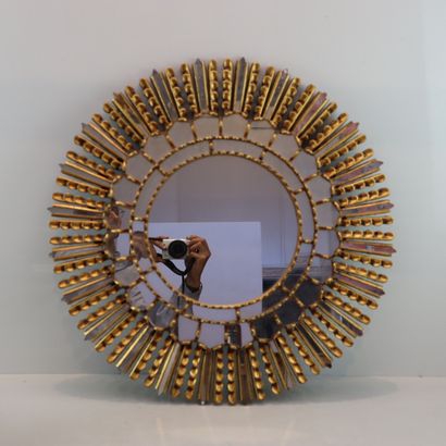 Round gilded metal mirror in the shape of...