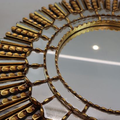 Round gilded metal mirror in the shape of...