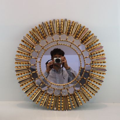 Round gilded metal mirror in the shape of...