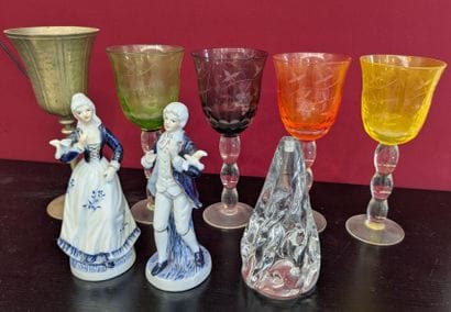 Set of glasses accompanied by two small figurines...