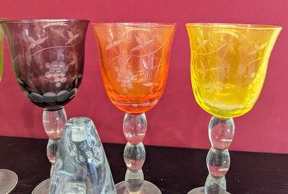 Set of glasses accompanied by two small figurines...