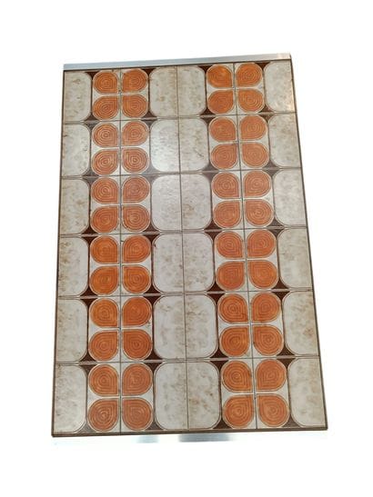 A metal table with a ceramic tile top - Circa...
