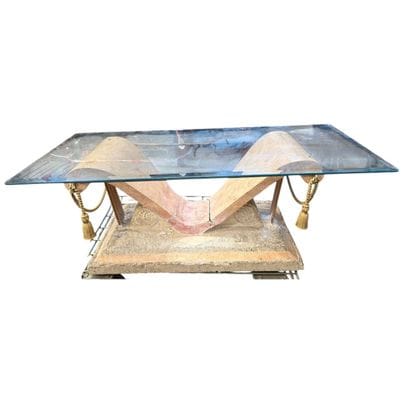 Coffee table with a glass top resting on...