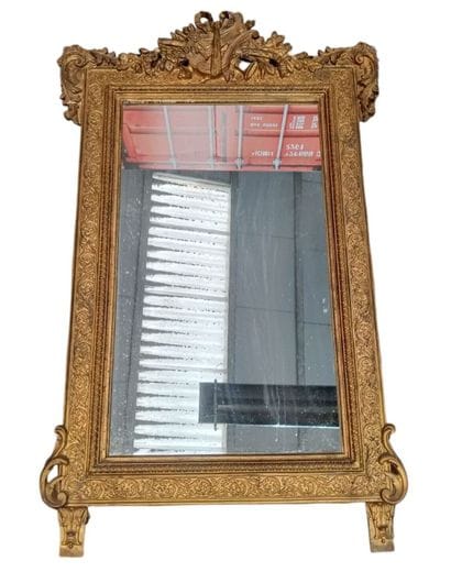 Large wooden mirror with gilded stucco 
featuring...