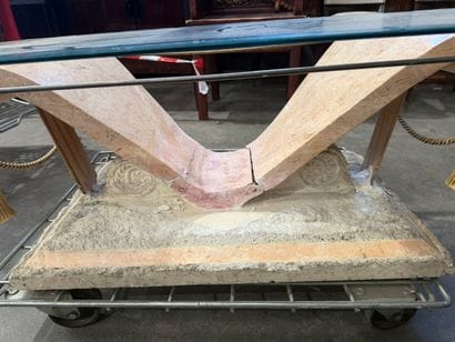 Coffee table with a glass top resting on...