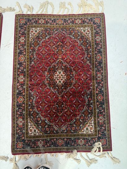 IRAN - Set of two floral-patterned rugs 
100...