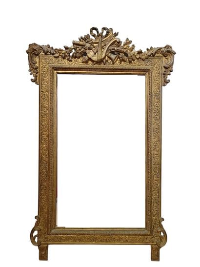 Large wooden mirror with gilded stucco 
featuring...