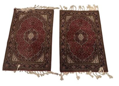 IRAN - Set of two floral-patterned rugs 
100...