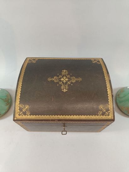 Leather liquor cabinet containing two bottles...