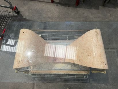 Coffee table with a glass top resting on...