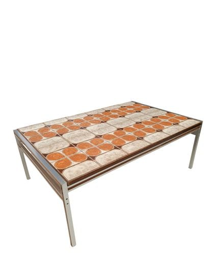 A metal table with a ceramic tile top - Circa...