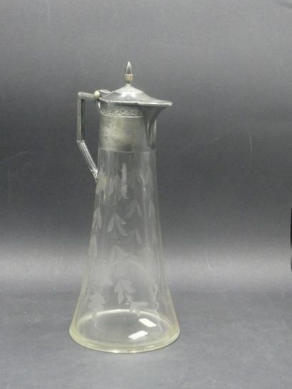 Cut crystal decanter. Silver strapping. Height:...