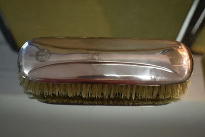 A silver toiletry set with three brushes...