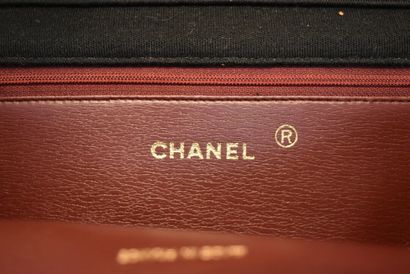 CHANEL. Black jersey clutch bag with flap,...