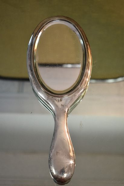 A silver toiletry set with three brushes...