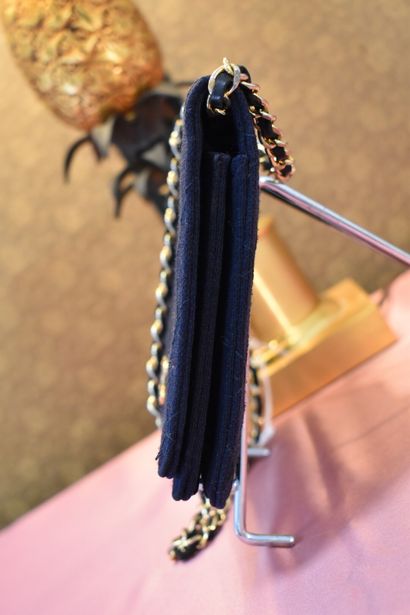 CHANEL. Navy blue jersey clutch bag with...