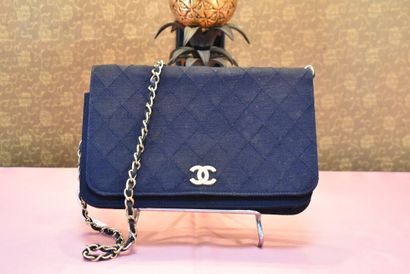CHANEL. Navy blue jersey clutch bag with...
