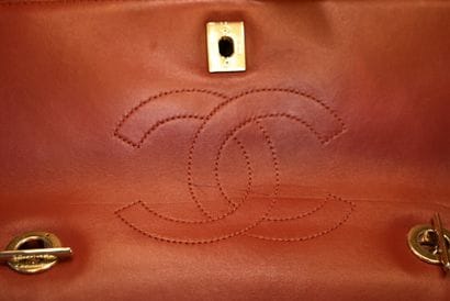 CHANEL. Red quilted lambskin handbag with...