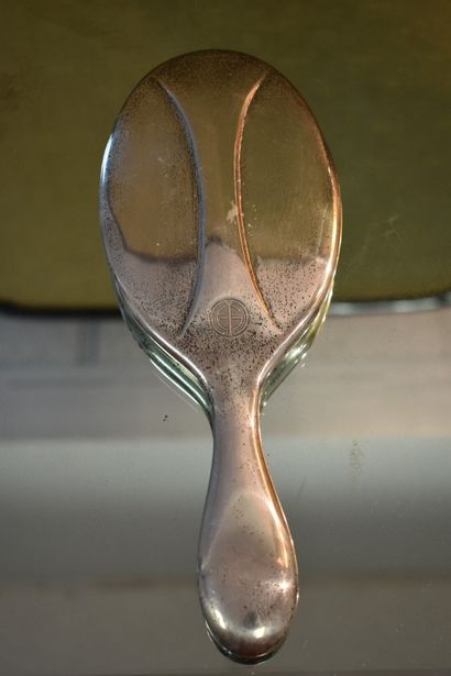 A silver toiletry set with three brushes...