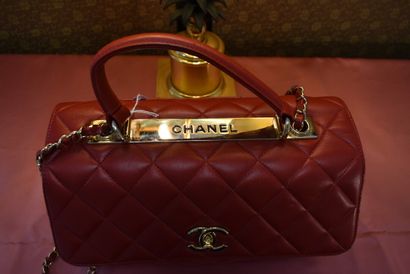 CHANEL. Red quilted lambskin handbag with...