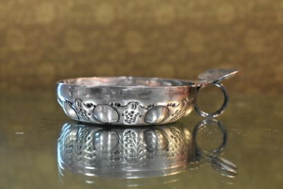 Silver wine tasting vessel with grapes and...