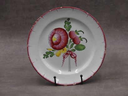 Une assiette en faïence, bords peignés et...