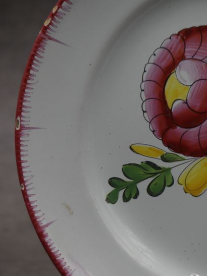 Une assiette en faïence, bords peignés et...