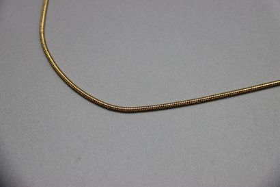 CHRISTIAN DIOR. Collier métal doré pendentif...