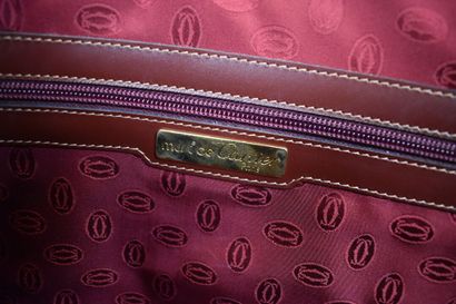 CARTIER. Grand sac de voyage en cuir grainé...