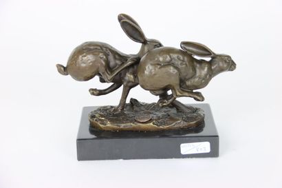 Bronze representing two hares running side...