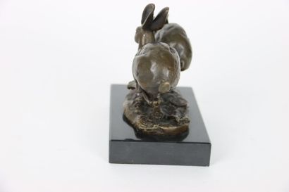 Bronze representing two hares running side...