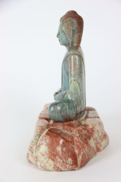ASIA. BUDDHA in meditation on a pile of rocks,...