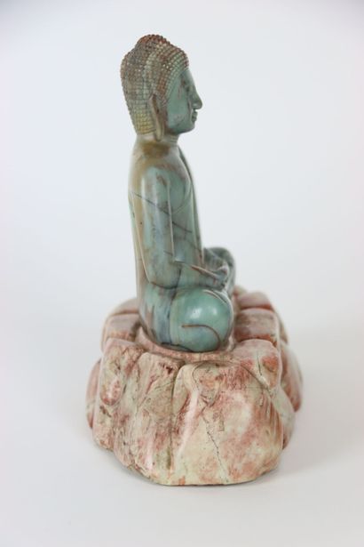 ASIA. BUDDHA in meditation on a pile of rocks,...