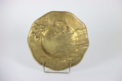Gilt bronze dish decorated in relief with...