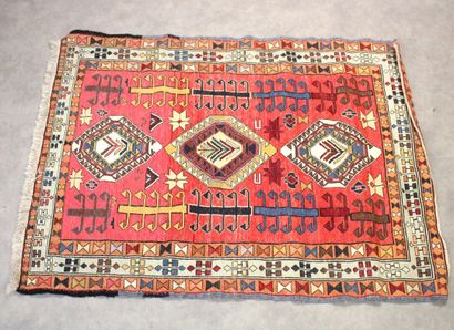 Knotted wool carpet with red border. 
Dimensions...