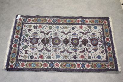Knotted wool carpet with blue border. 
Dimensions...
