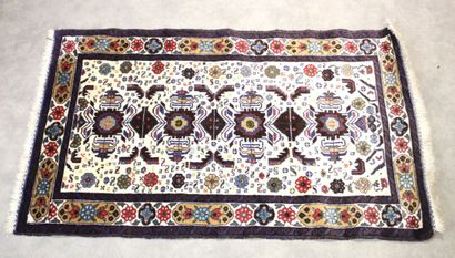 Knotted wool carpet with blue border. 
Dimensions...