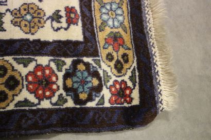 Knotted wool carpet with blue border. 
Dimensions...