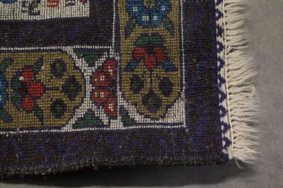 Knotted wool carpet with blue border. 
Dimensions...