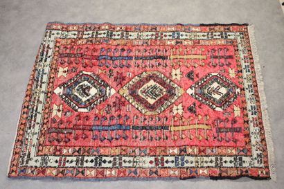 Knotted wool carpet with red border. 
Dimensions...