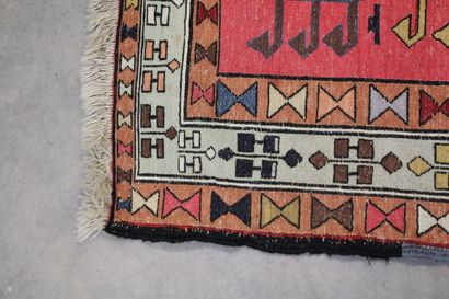 Knotted wool carpet with red border. 
Dimensions...