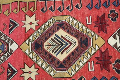 Knotted wool carpet with red border. 
Dimensions...
