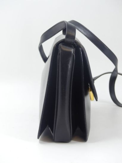 GUCCI. Black leather clutch bag, gold metal...