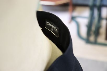 CHANEL. Meeting of two black wool skirts,...